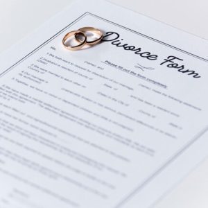 divorce-form-with-wedding-rings-table_23-2148548577